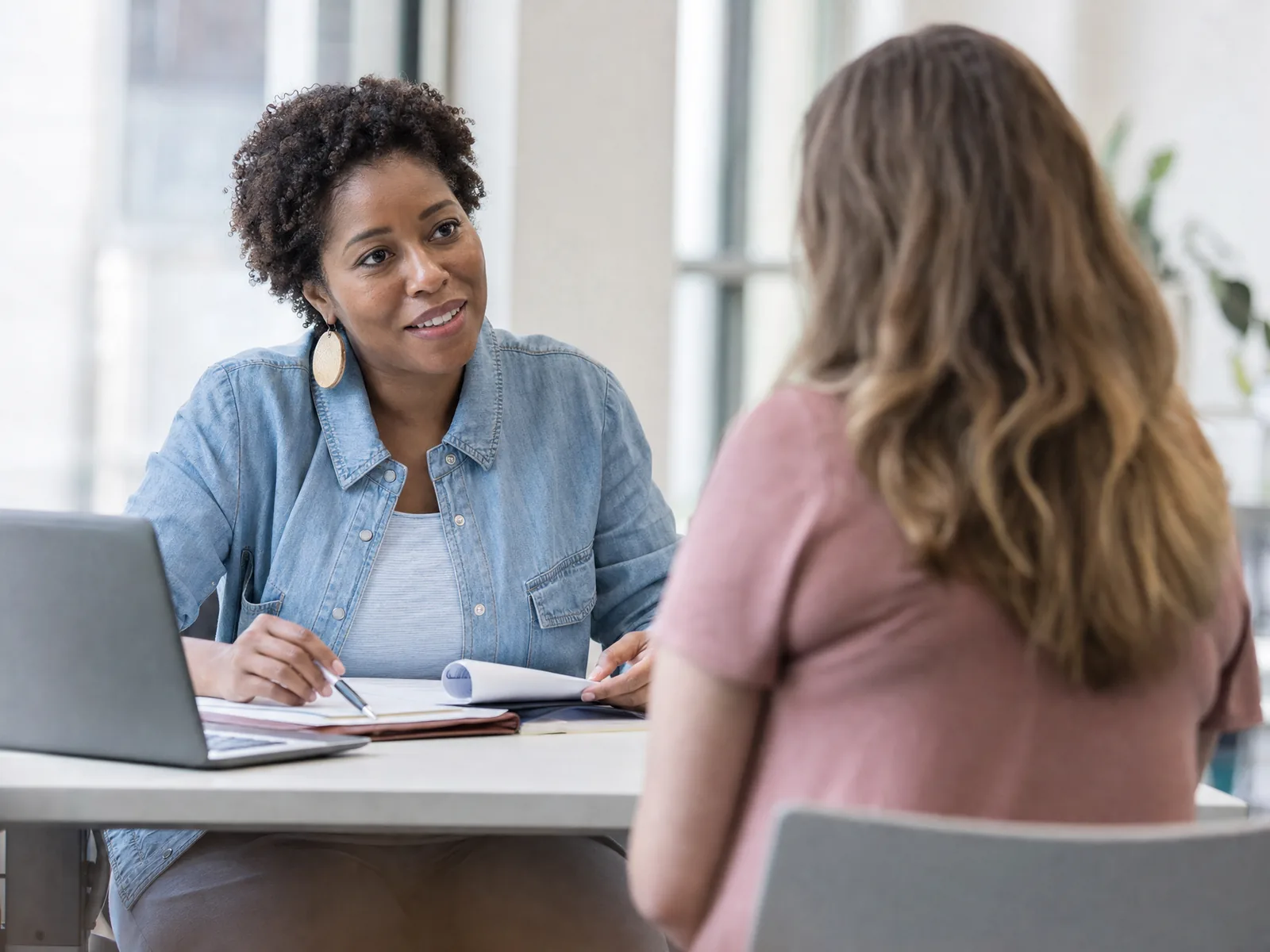 A job coach at a community workforce center in conversation with a program participant